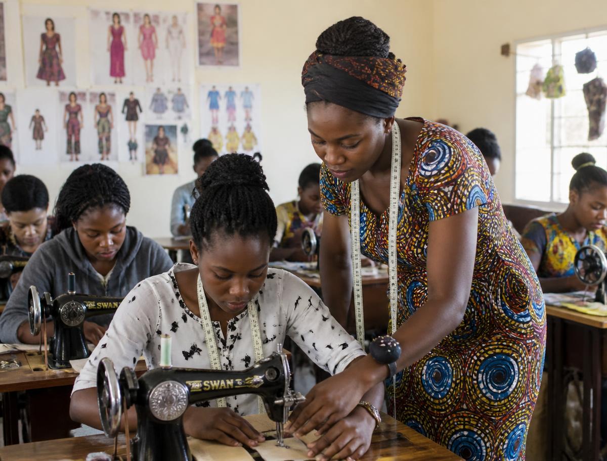 Students learning garment construction on sewing machines